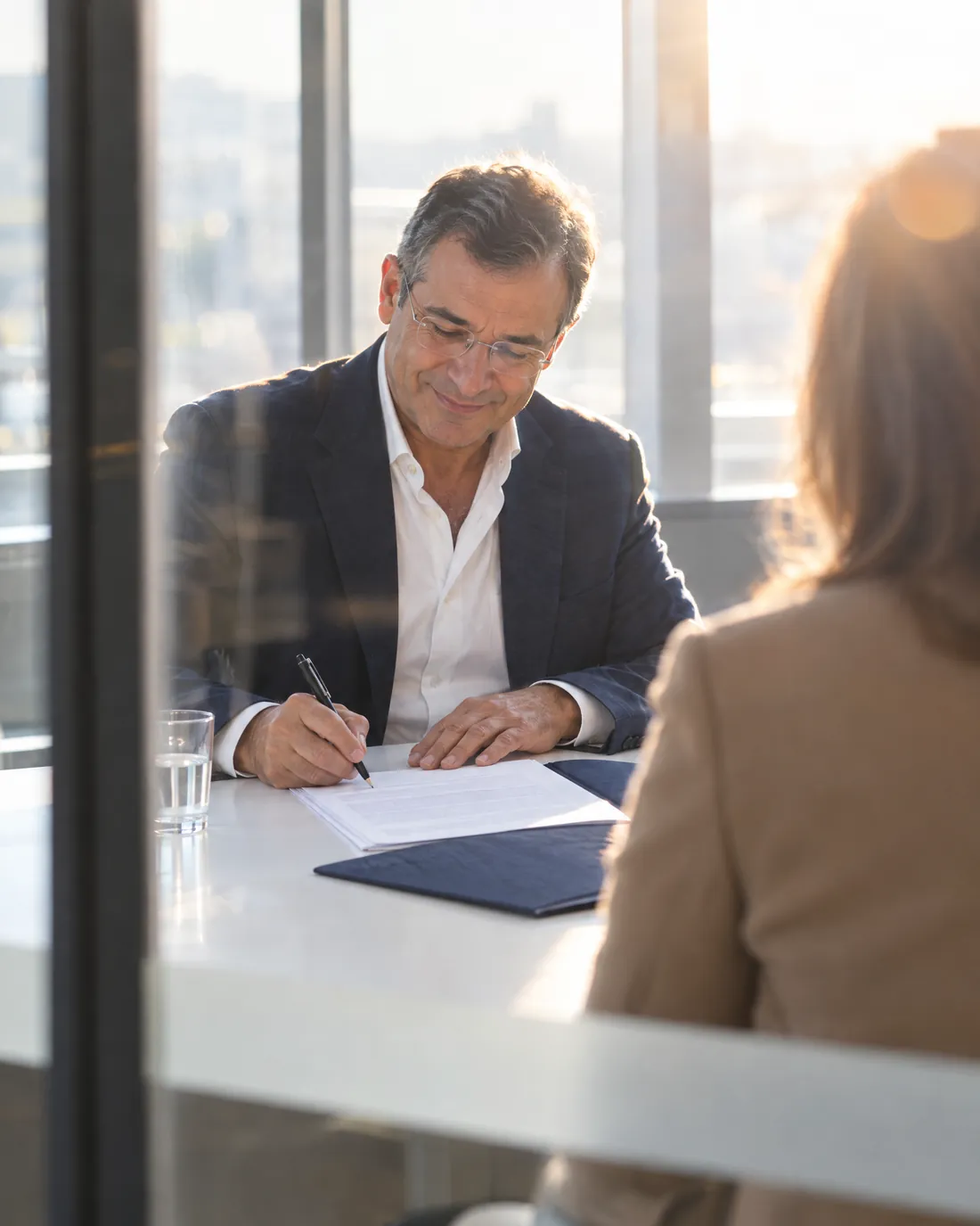 A business owner signing the final page of a sale agreement